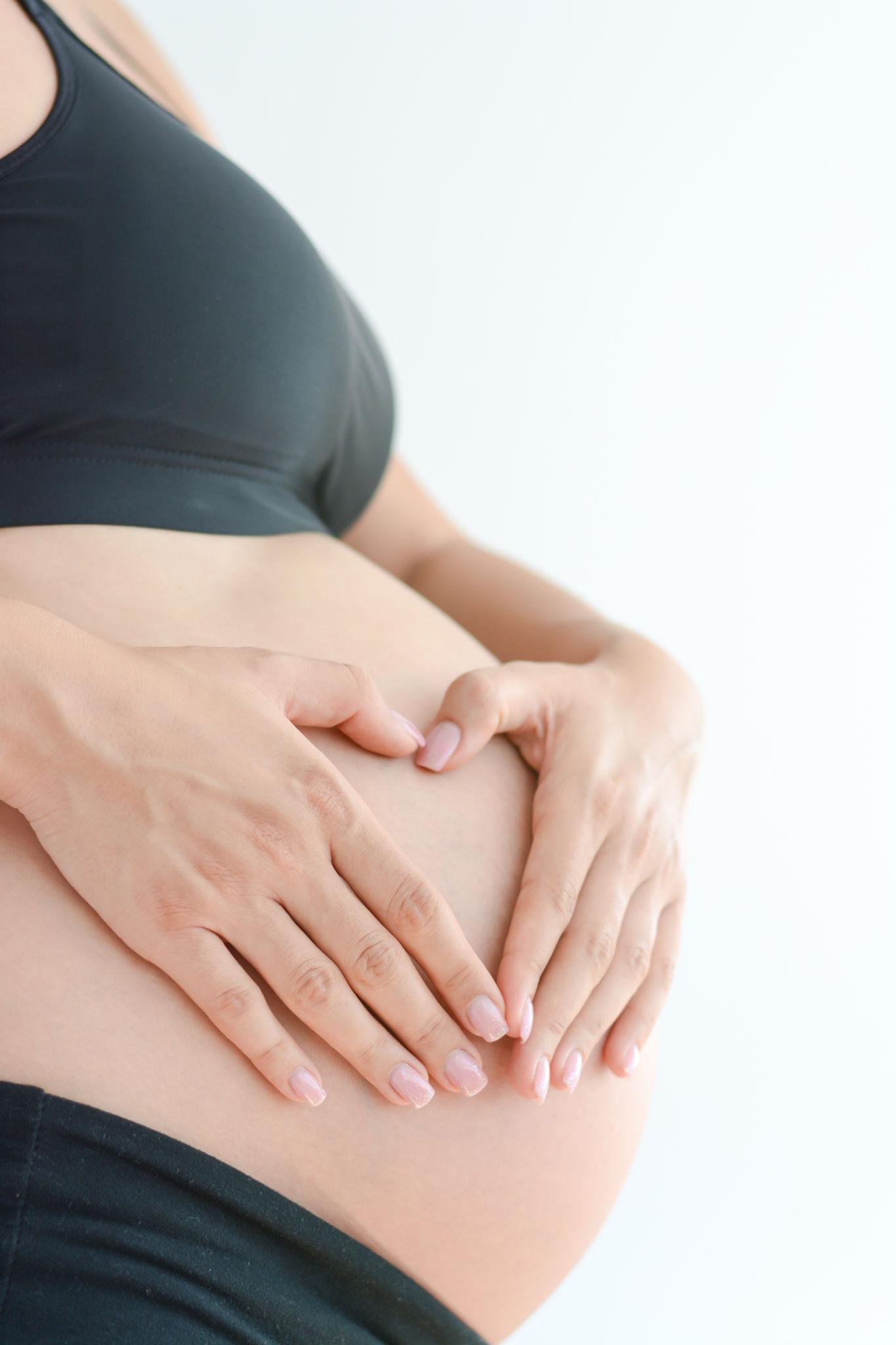 Pregnant woman holding her bump